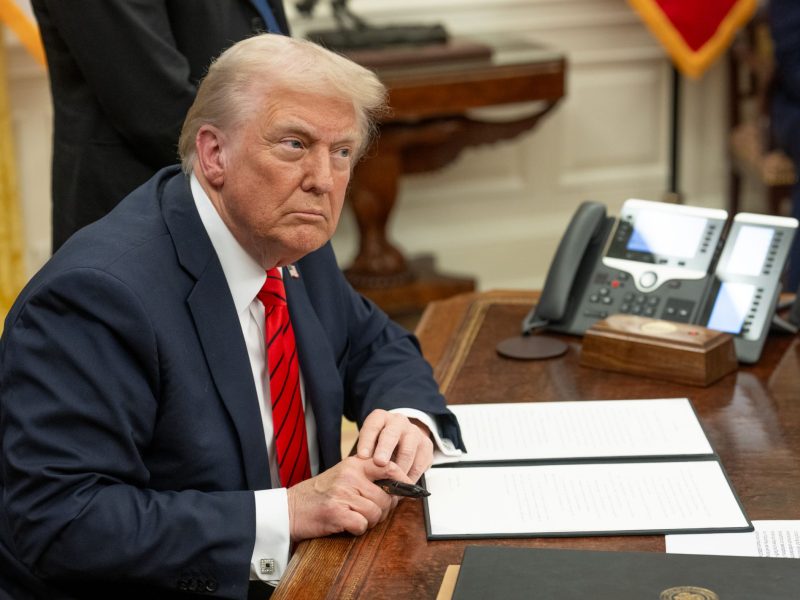 President Donald Trump signs executive orders on February 10, in the Oval Office. Credit: Official White House photo by Abe McNatt