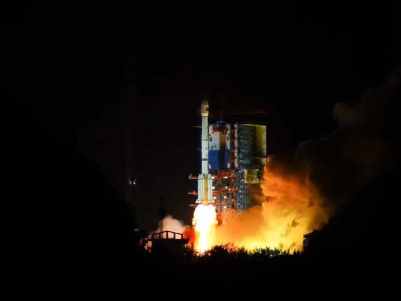 A Long March 3B rocket lifts off from Xichang Satellite Launch Center at night, illuminating the launch pad with bright orange exhaust flames during the launch of the classified TJS-17 satellite on April 10, 2025.