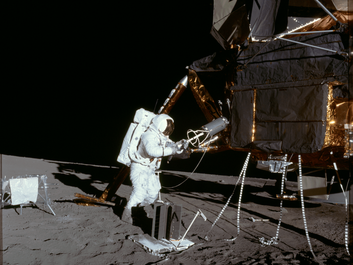 Apollo 12 astronaut Alan Bean extracts the fuel element of a Radioisotope Thermoelectric Generator (RTG) from storage on the lunar module on the Moon. Credit: NASA