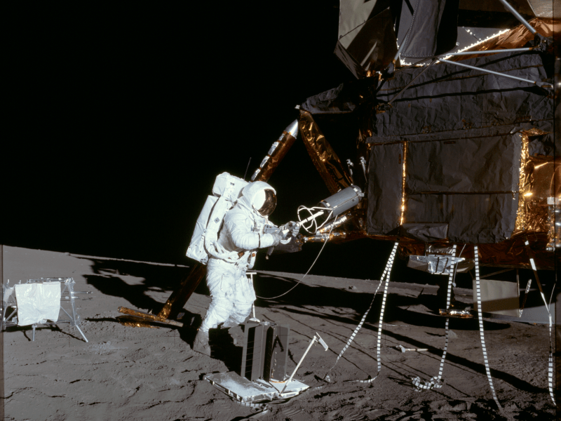 Apollo 12 astronaut Alan Bean extracts the fuel element of a Radioisotope Thermoelectric Generator (RTG) from storage on the lunar module on the Moon. Credit: NASA
